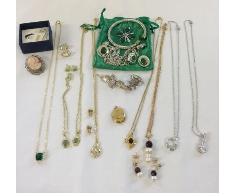 A quantity of costume jewellery to include, a cameo brooch, bangle and necklace & earring sets.