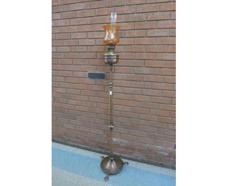 An Arts and Crafts brass and copper telescopic floor standing oil lamp 