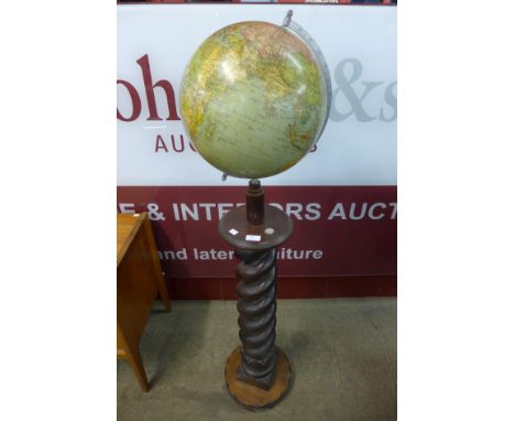 A vintage terrestrial globe , on carved beech barleytwist stand 