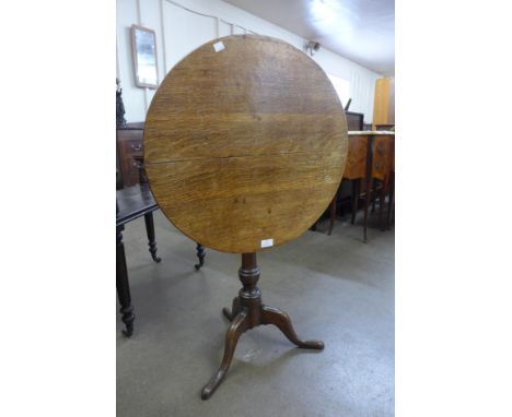 A George III oak circular tilt top tripod table 