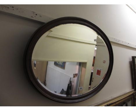 Oval mahogany bevel edged wall mirror and 20th Century turned and reeded column standard lamp