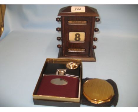 Early 20th Century oak desk calendar, a Stratton compact and a hip flask