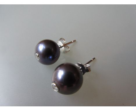 Pair of 18ct black cultured pearl and diamond inset stud earrings