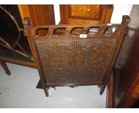 Art Nouveau oak framed leather inset firescreen with stylised floral embossed decoration