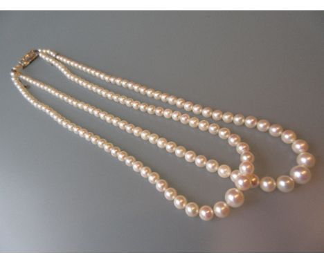 Double row graduated cultured pearl necklace with diamond chip set clasp
