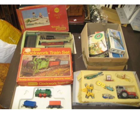 Boxed Triang clockwork part train set, another similar Hornby box containing a part train set, Britains tractor and accessori