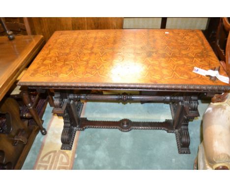 19th Century Continental rectangular oak side table with a parquetry inlaid top above a carved frieze and end supports with a