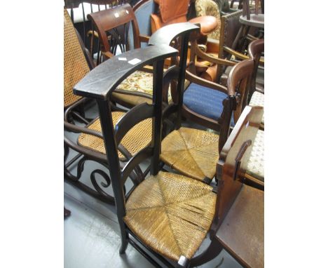 Pair of Arts and Crafts style ebonised side chairs with wicker seats together with an ebonised open armchair with cane back a