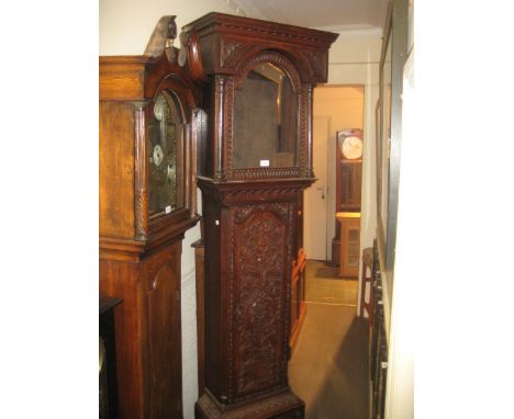 George III carved oak longcase clock case, the broken arch hood above an arched panel door and conforming plinth base with la