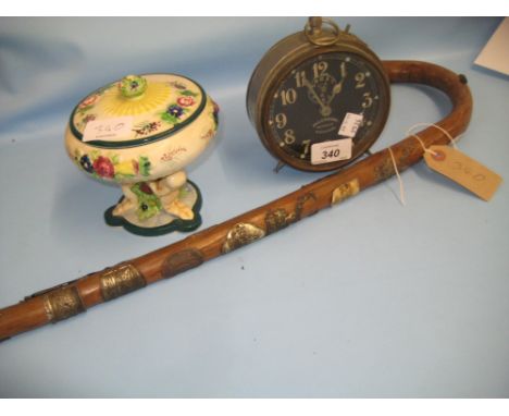 Early Ingersoll alarm clock, an alpine walking cane and a Japanese pottery pedestal vase and cover