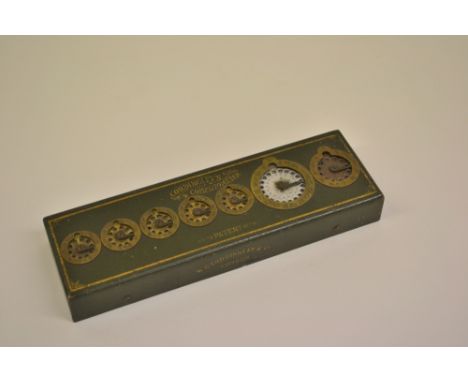 Cordingley's Computometer, the rectangular green and gilt decorated metal case set with seven stylus operated dials, stamped 