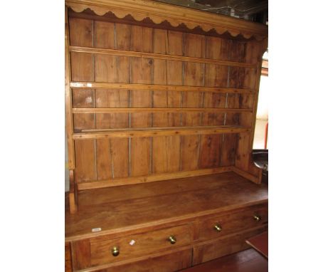 Small 19th Century stripped pine dresser, the boarded shelf back above two drawers and two rectangular panel doors on plinth 