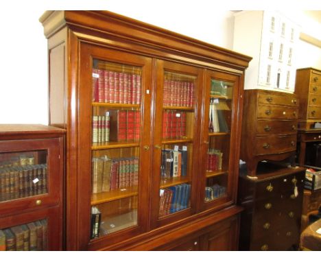 Reproduction French cherry wood bookcase with moulded cornice above three bevelled glass doors and three fielded panel doors