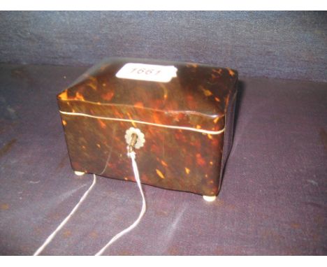Small 19th Century tortoiseshell tea caddy, the hinged cover enclosing an inner lid above a serpentine front and turned ivory