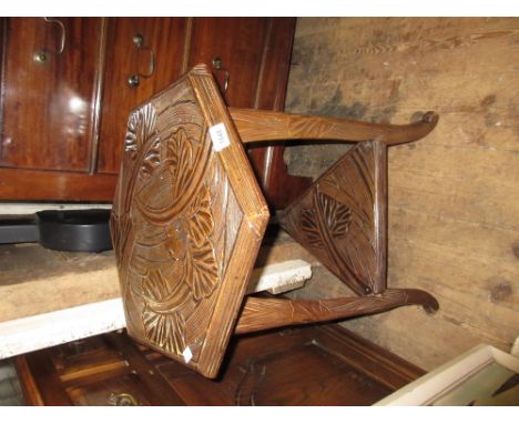 Arts and Crafts style hexagonal all-over floral carved tripod table with undertier