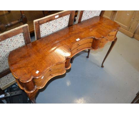 Birds eye maple shallow side table, the shaped moulded top above six serpentine fronted drawers with knob handles raised on c