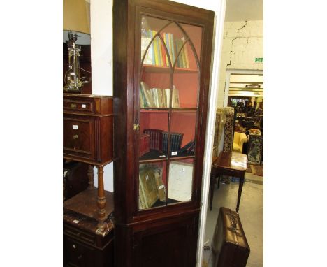 19th Century mahogany and black line inlaid standing corner cabinet with Gothic arched bar glazed door, enclosing shelves abo