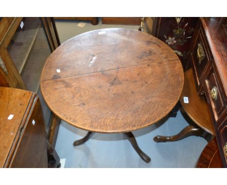 Mid 18th Century oak pedestal table, the circular top with a baluster column and tripod support