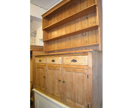 Large 19th Century stripped pine dresser, the boarded shelf back above three drawers and three cupboard doors