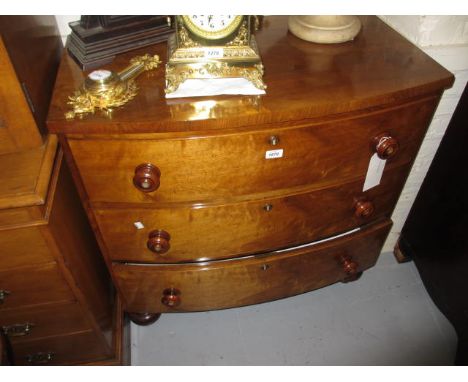 19th Century figured mahogany bow front chest of three graduated drawers with mother of pearl inlaid knob handles and turned 