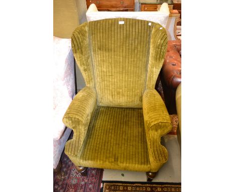 Early 20th Century upholstered wing armchair in 18th Century style raised on baluster turned front supports