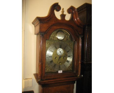 George III oak longcase clock, the broken arch hood with swan neck pediment and flanking pilasters above an arched panel door