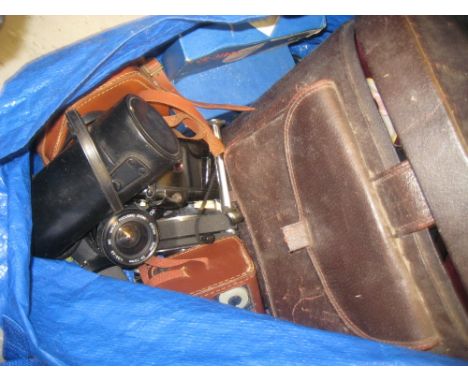 Box containing a quantity of various 20th Century S.L.R. cameras and camera lenses etc