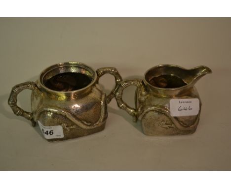 Japanese silver cream jug and sugar basin embossed with dragons with the handles simulated as bamboo