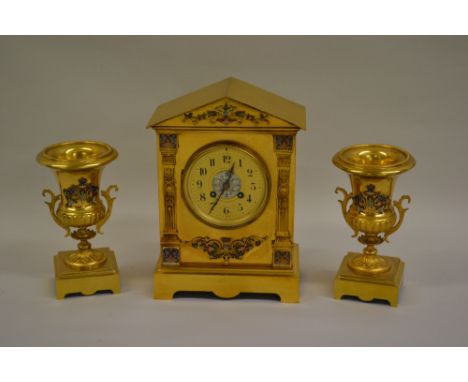 Late 19th or early 20th Century French gilt brass and champleve enamel three piece clock garniture, the architectural case wi