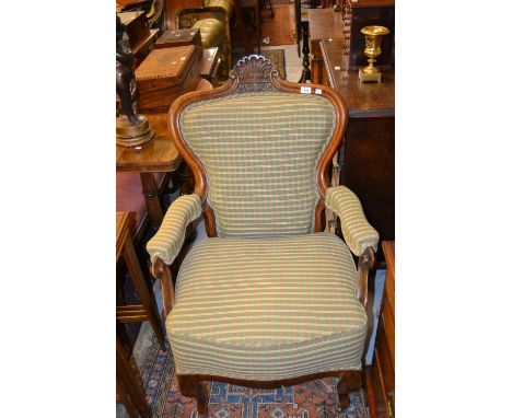 19th Century continental walnut spoon back open armchair, having shell carved back and modern green checked upholstery, raise