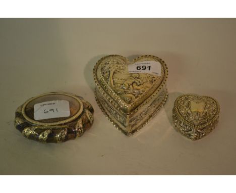 Victorian silver heart shaped trinket box, the embossed lid decorated with a scene depicting cupid together with similar smal