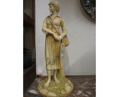 Large Hadley Worcester blush ivory figure of a standing girl carrying a wicker basket, 16.5ins high
