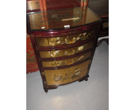 20th Century bow fronted floral decorated lacquered chest / side cabinet with gilt decoration, having three drawers above two