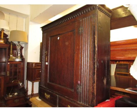 18th Century oak wall cabinet having moulded castellated cornice above a single panel door, flanked by reeded decoration abov