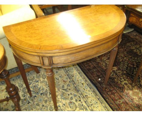 George III satinwood and rosewood crossbanded D shaped fold-over card table, the line inlaid top above a moulded frieze with 