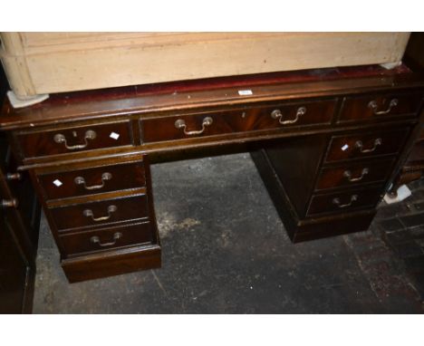 Reproduction mahogany twin pedestal desk together with a mahogany two shelf open bookcase