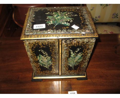 Victorian black lacquered and mother of pearl inlaid papier mache sewing cabinet, the moulded top above a pair of panelled do