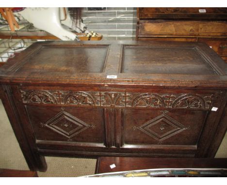 Small 17th Century oak coffer, the hinged two panel lid above a carved frieze and twin moulded panel front on stile supports