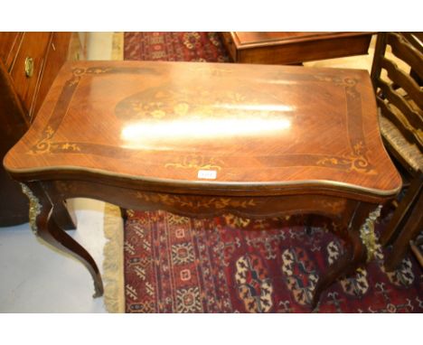 Late 19th Century French floral marquetry and inlaid serpentine fronted fold-over card table with gilt brass mounts and cabri