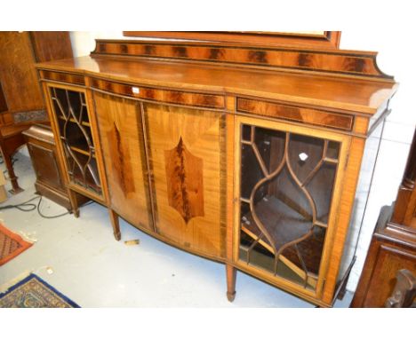 Edwardian mahogany crossbanded and line inlaid semi bow fronted side cabinet, the low moulded back above a pair of central bo