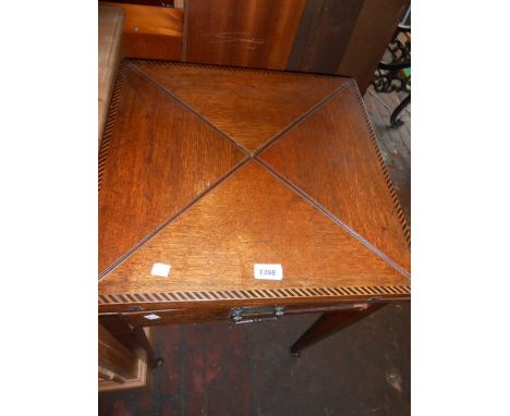 Edwardian oak and inlaid envelope card table raised on square tapering supports