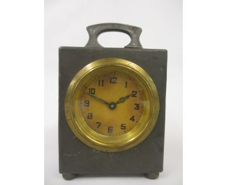 Liberty and Co. pewter cased mantel clock with folding carrying handle and circular paper dial with Arabic numerals