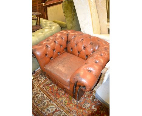 Brown leather button upholstered and brass studded Chesterfield armchair
