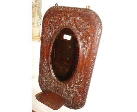 Arts &amp; Crafts carved oak mirror with candle shelf