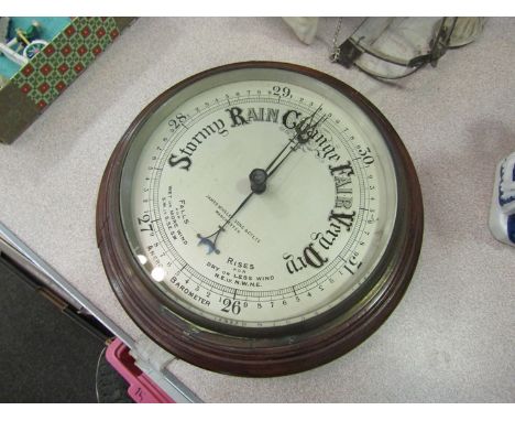 An aneroid barometer by James Wooley &amp; Co Ltd, Manchester, mahogany and brass case 20cm diameter face, silvered dial, cir