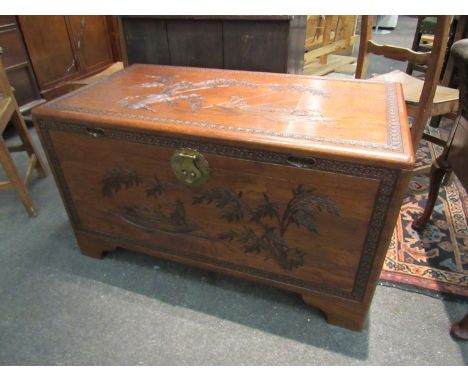 A mid 20th Century Southeast Asia camphor wood trunk with carved decoration and sliding tray (with lock), 101cm x 55cm x 56cm