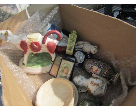 A box containing assorted items including a 19th Century cow creamer, a porcelain patch box, miniature vases and paintings
