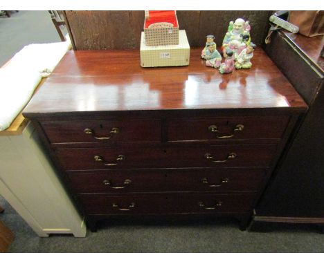 A late George III mahogany chest of two short over three graduating long drawers with brass swan neck handles over bracket fe