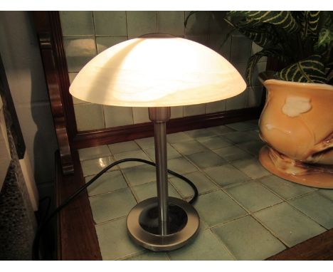 A touch lamp with opaque glass shade