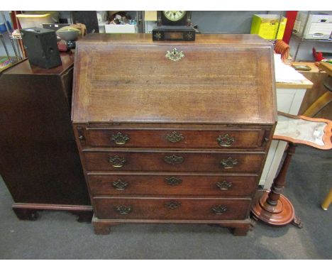 A circa 1780 oak bureau, the fitted interior over four long drawers on bracket feet, with key, 111cm tall x 93cm wide x 50cm 